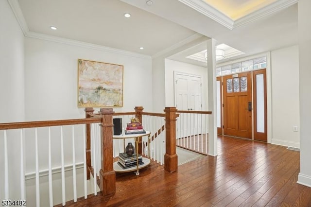 entrance foyer with ornamental molding and wood-type flooring