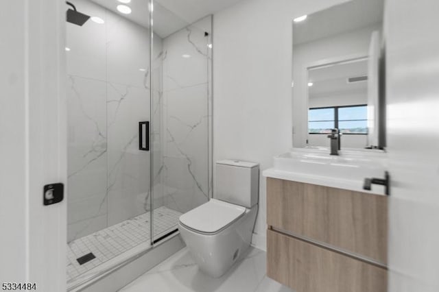 bathroom with vanity, a shower with door, and toilet