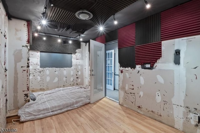 interior space featuring track lighting and hardwood / wood-style floors