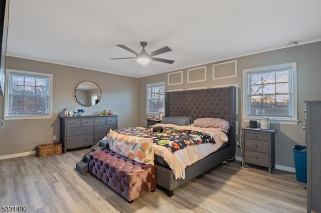 bedroom with crown molding, ceiling fan, and light hardwood / wood-style flooring