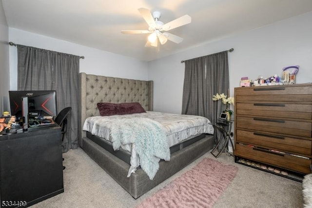 bedroom with light carpet and ceiling fan