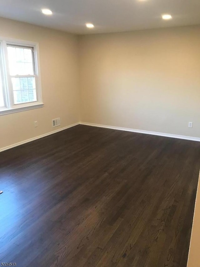 unfurnished room featuring dark hardwood / wood-style flooring