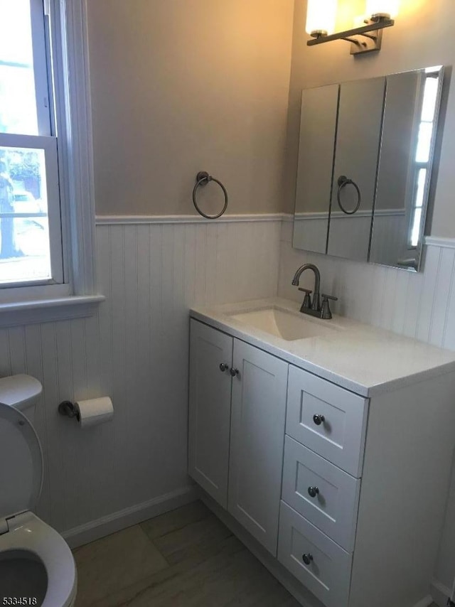 bathroom featuring vanity and toilet