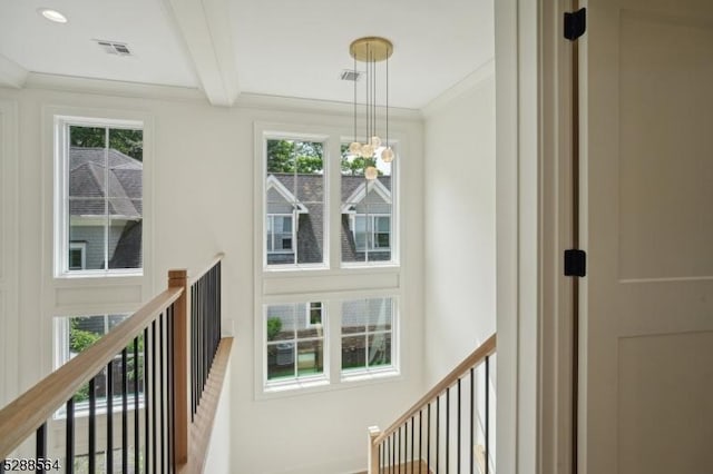 hall with beam ceiling and crown molding