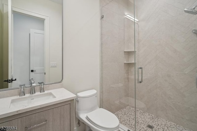 bathroom with vanity, an enclosed shower, and toilet