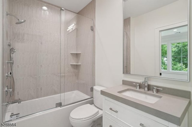 full bathroom with toilet, vanity, and enclosed tub / shower combo