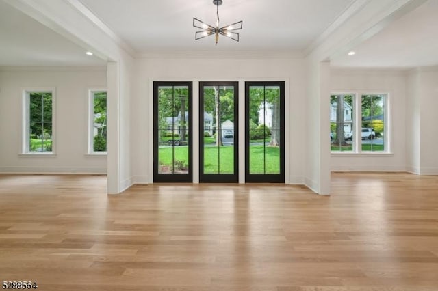 entryway featuring light hardwood / wood-style flooring, an inviting chandelier, and ornamental molding