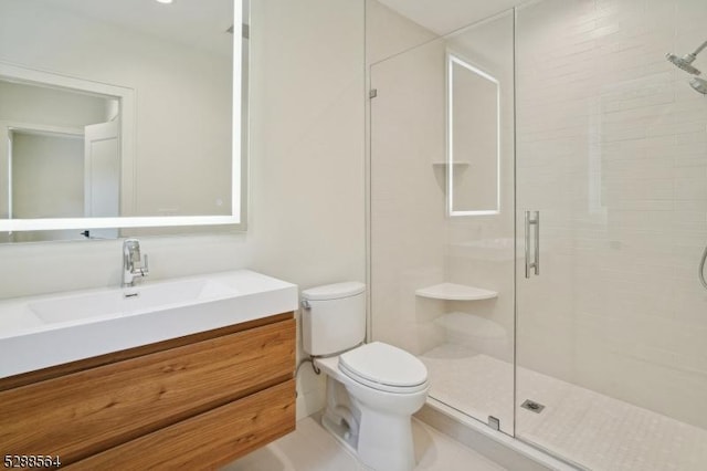 bathroom featuring vanity, toilet, and walk in shower