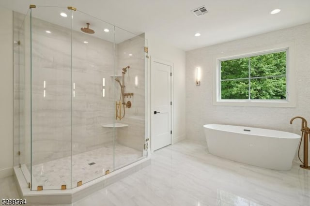 bathroom featuring shower with separate bathtub