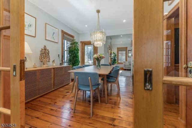 dining area featuring an inviting chandelier and light wood-type flooring