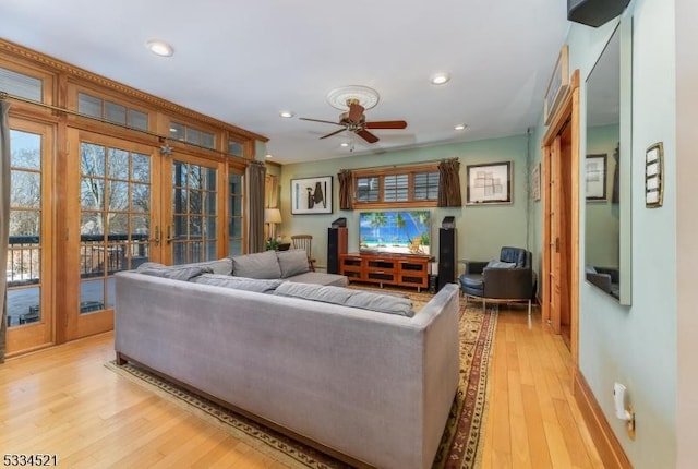 living room featuring light hardwood / wood-style flooring, french doors, and ceiling fan