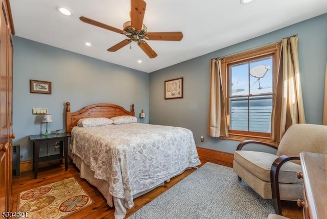 bedroom with wood-type flooring and ceiling fan