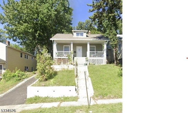 bungalow featuring a porch and a front yard