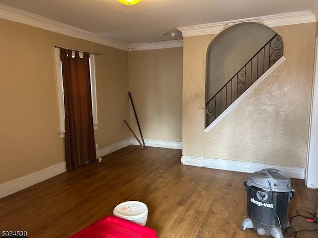 unfurnished room featuring crown molding and wood-type flooring