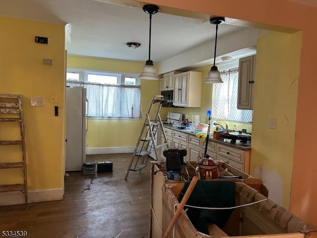 kitchen with white refrigerator, decorative light fixtures, dark hardwood / wood-style flooring, and cream cabinets