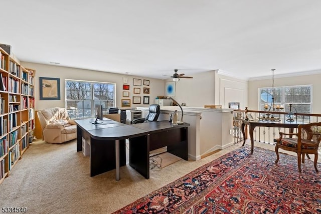 home office with light carpet, plenty of natural light, and ornamental molding