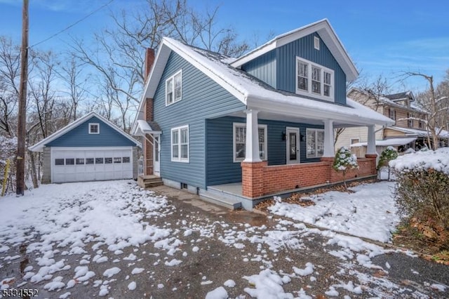 view of front of home with an outbuilding, a garage, and a porch