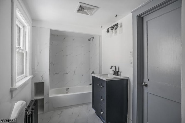 bathroom with a healthy amount of sunlight, vanity, and radiator heating unit