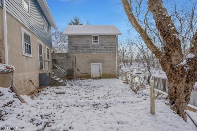 view of snow covered rear of property