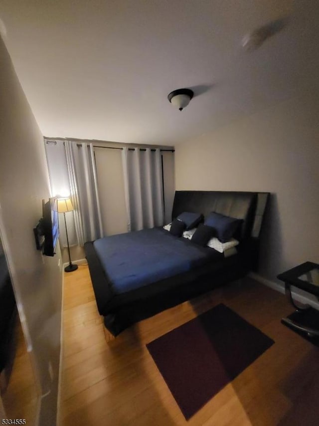 bedroom with wood-type flooring