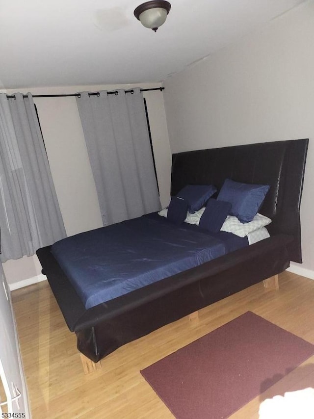 bedroom featuring ceiling fan and wood-type flooring