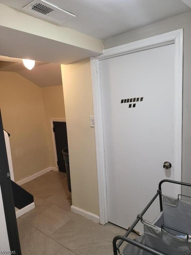 hallway featuring lofted ceiling