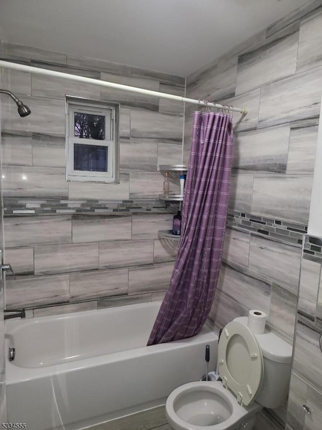 bathroom with shower / bath combo with shower curtain and toilet