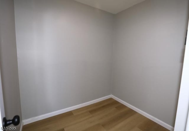 empty room with hardwood / wood-style flooring