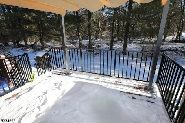 snow covered deck featuring a swimming pool