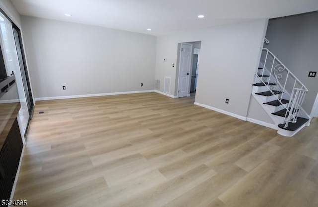 basement with light hardwood / wood-style floors