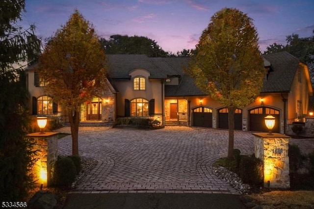 french country style house with a garage