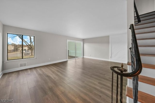 unfurnished living room with dark wood-type flooring