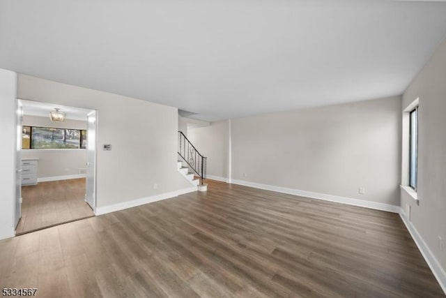 unfurnished living room with dark wood-type flooring