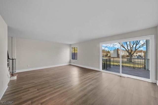 empty room featuring dark hardwood / wood-style flooring