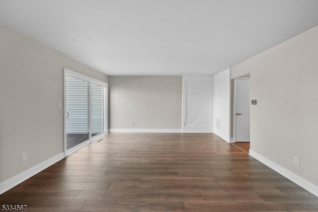 empty room with dark wood-type flooring