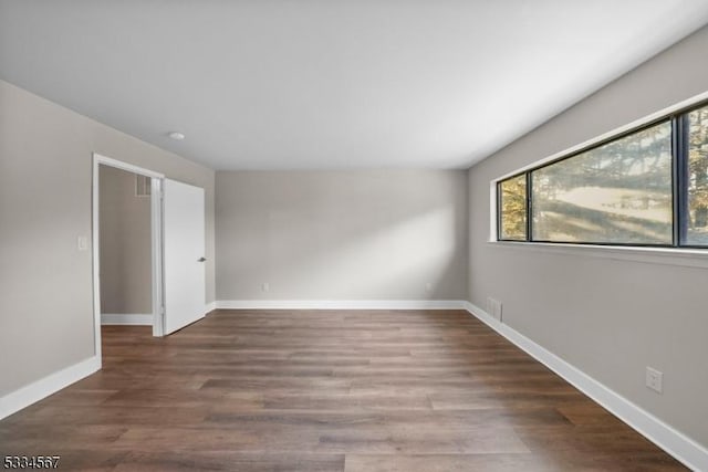 spare room with dark hardwood / wood-style flooring