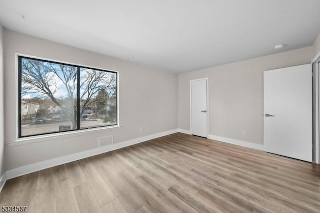 spare room featuring light hardwood / wood-style flooring