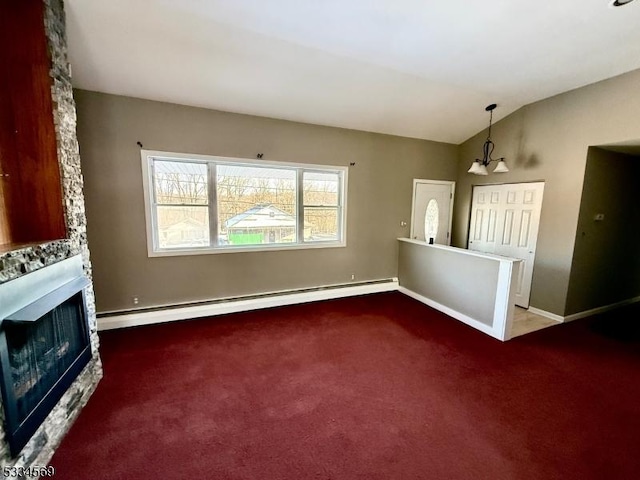 unfurnished living room with vaulted ceiling, a baseboard radiator, a stone fireplace, and carpet flooring