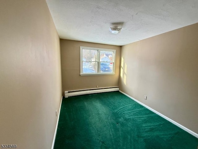 carpeted spare room with a textured ceiling and baseboard heating