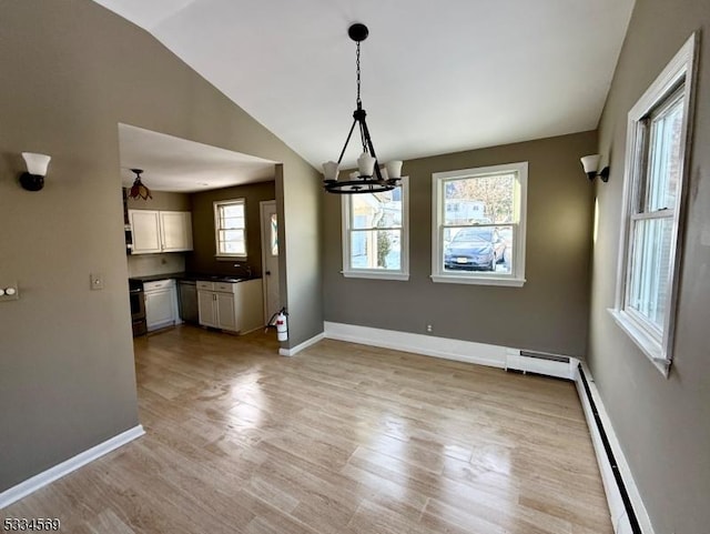 unfurnished dining area featuring an inviting chandelier, a baseboard radiator, lofted ceiling, and light wood-type flooring