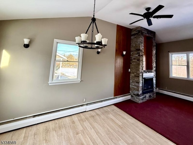 unfurnished living room featuring lofted ceiling, a fireplace, wood-type flooring, and a baseboard heating unit