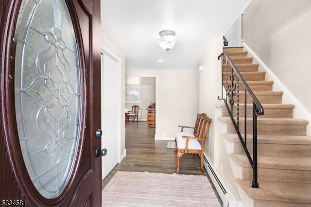 entryway with dark hardwood / wood-style flooring and a baseboard heating unit