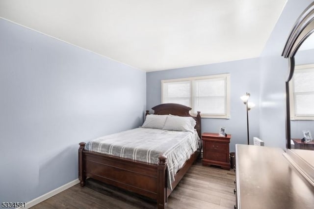 bedroom featuring dark wood-type flooring and multiple windows