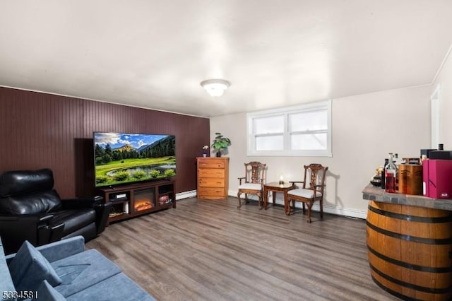 living room with a baseboard heating unit and hardwood / wood-style flooring