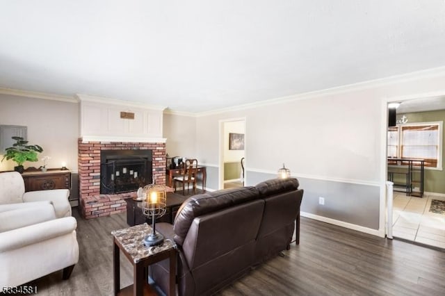 living room featuring a fireplace, ornamental molding, and dark hardwood / wood-style floors