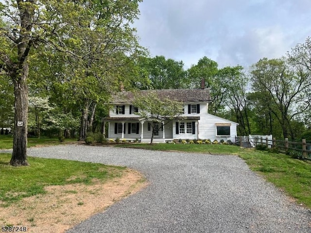 colonial inspired home with a front lawn