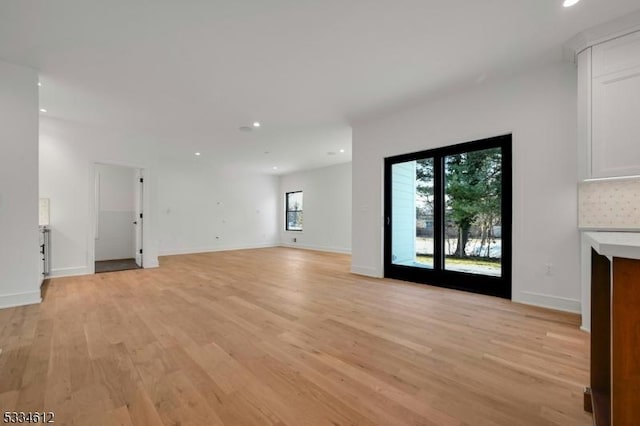 unfurnished living room featuring light hardwood / wood-style floors