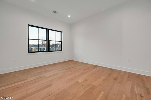 spare room featuring light wood-type flooring