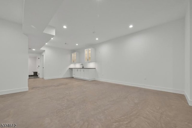 unfurnished living room featuring sink