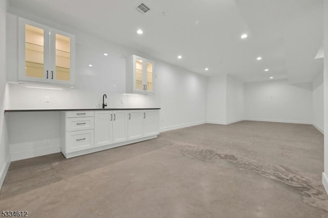 interior space featuring white cabinetry and sink